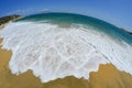 Golden sandy beach with white waves