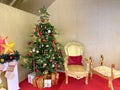Golden Santa chair beside the Christmas tree Royalty Free Stock Photo