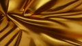 The golden satin fabric is crumpled. The gold bedspread with folds glitters and shimmers in the light Royalty Free Stock Photo