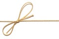 Golden satin rope parallel to frame with knotted bow gift ribbon wrap for Christmas present with intricate shine details.