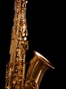 Golden saxophone on dark background.