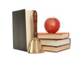 Golden school bell with wooden handle, apple and books on white background Royalty Free Stock Photo