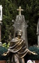 Golden sculpture praying under the cross