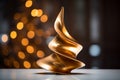 a golden sculpture sitting on a table in front of a christmas tree