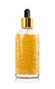 Golden serum in glass bottle on white background