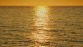 Golden Shimmering Sea Waves In Sun. View Of Calm Waves. Peaceful Summer Sunset Background.