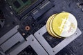 Golden bitcoins with flag of vatican city on a computer electronic circuit board. bitcoin mining concept