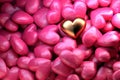 Golden shining heart on a background of pink shiny hearts. Beautiful festive backdrop for Valentine`s day.