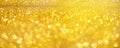 Golden shiny background, copy space for your Christmas greetings. Banner with defocused lights, bright yellow bokeh. Shimmer of Royalty Free Stock Photo