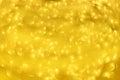 Golden shiny background, copy space for your Christmas greetings. Banner with defocused lights, bright yellow bokeh. Shimmer of Royalty Free Stock Photo