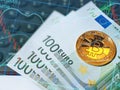 Golden shiny bitcoin and euro banknotes on computer keyboard Royalty Free Stock Photo