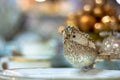 Golden shiny decorative christmas bird .Shallow depth of field