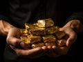 Golden shiny nuggets the hands of the miner. The working palms with metal gold. Black background