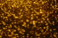 Golden shiny rain, gold round sparkles blurred background