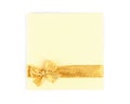 Golden shiny satin ribbon with bow, and yellow card on a white background isolated. Royalty Free Stock Photo