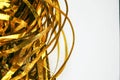 Golden shiny tinsel ribbons. Golden sequins, sparkling stripes of serpentine. Festive decor for new year, birthday, party.