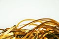 Golden shiny tinsel ribbons. Golden sequins, sparkling stripes of serpentine. Festive decor for new year, birthday, party.