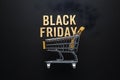 Golden shopping cart on dark background, Black Friday concept