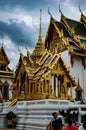 Golden shrine, honoring of the Buddha within the walls of the Royal Palace with tourists around