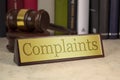Golden sign with gavel and complaints