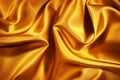 Golden silk satin. Wavy folds. Shiny surface fabric. Beautiful silky background Royalty Free Stock Photo