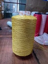 Golden silver blended yarn bobbin but on floor in textile industry