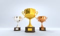 Golden, silver and bronze cup, award trophy or winner prize on wooden pedestal with empty gold plate for championship Royalty Free Stock Photo