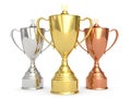 Golden, silver and bronze trophy cups on white