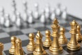 Golden and Silver chess surrounded by a number of fallen chess pieces, business strategy, chess battle, victory, success, teamwork Royalty Free Stock Photo