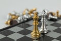 Golden and Silver chess surrounded by a number of fallen chess pieces, business strategy, chess battle, victory, success, teamwork Royalty Free Stock Photo