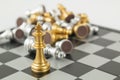 Golden and Silver chess surrounded by a number of fallen chess pieces, business strategy, chess battle, victory, success, teamwork Royalty Free Stock Photo