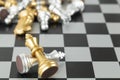 Golden and Silver chess surrounded by a number of fallen chess pieces, business strategy, chess battle, victory, success, teamwork Royalty Free Stock Photo