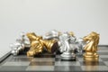 Golden and Silver chess surrounded by a number of fallen chess pieces, business strategy, chess battle, victory, success, teamwork Royalty Free Stock Photo