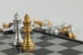 Golden and Silver chess surrounded by a number of fallen chess pieces, business strategy, chess battle, victory, success, teamwork Royalty Free Stock Photo