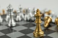 Golden and Silver chess surrounded by a number of fallen chess pieces, business strategy, chess battle, victory, success, teamwork Royalty Free Stock Photo