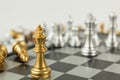 Golden and Silver chess surrounded by a number of fallen chess pieces, business strategy, chess battle, victory, success, teamwork Royalty Free Stock Photo