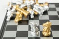 Golden and Silver chess surrounded by a number of fallen chess pieces, business strategy, chess battle, victory, success, teamwork Royalty Free Stock Photo