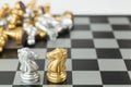 Golden and Silver chess surrounded by a number of fallen chess pieces, business strategy, chess battle, victory, success, teamwork Royalty Free Stock Photo