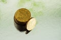 Golden and silver coins on silver background. Tip euro 20 and 10 cent Royalty Free Stock Photo