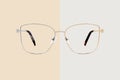 Golden and silver glasses isolated on beige and gray background, ideal photo template for display or advertising sign or for a web