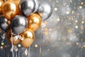 Golden and silver gray metallic glitter balloons and confetti on glistering background. Birthday, holiday or party background. Royalty Free Stock Photo