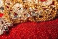 Golden and silver jewelry on red shiny glitter background Royalty Free Stock Photo