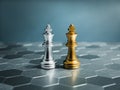 Golden and silver king, luxury chess pieces standing together on a silver hexagon pattern chessboard on blue background. Royalty Free Stock Photo