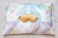 Golden sleeping eye mask on the bed, top view. Good night, flight and travel concept. Sweet dreams, siesta, insomnia, relaxation,