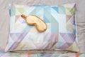 Golden sleeping eye mask on the bed, top view. Good night, flight and travel concept. Sweet dreams, siesta, insomnia, relaxation,