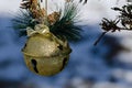 Golden Sleigh Bell Christmas Ornament Decorating an Outdoor Tree Royalty Free Stock Photo