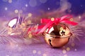 Golden sleigh bells and fir branches on table, closeup