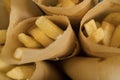 Fast food. French fries in parchment paper. Macro. Studio light