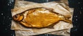 Golden smoked river bream on dark background, top view Royalty Free Stock Photo