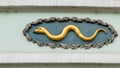 Golden snake, decoration on a house facade